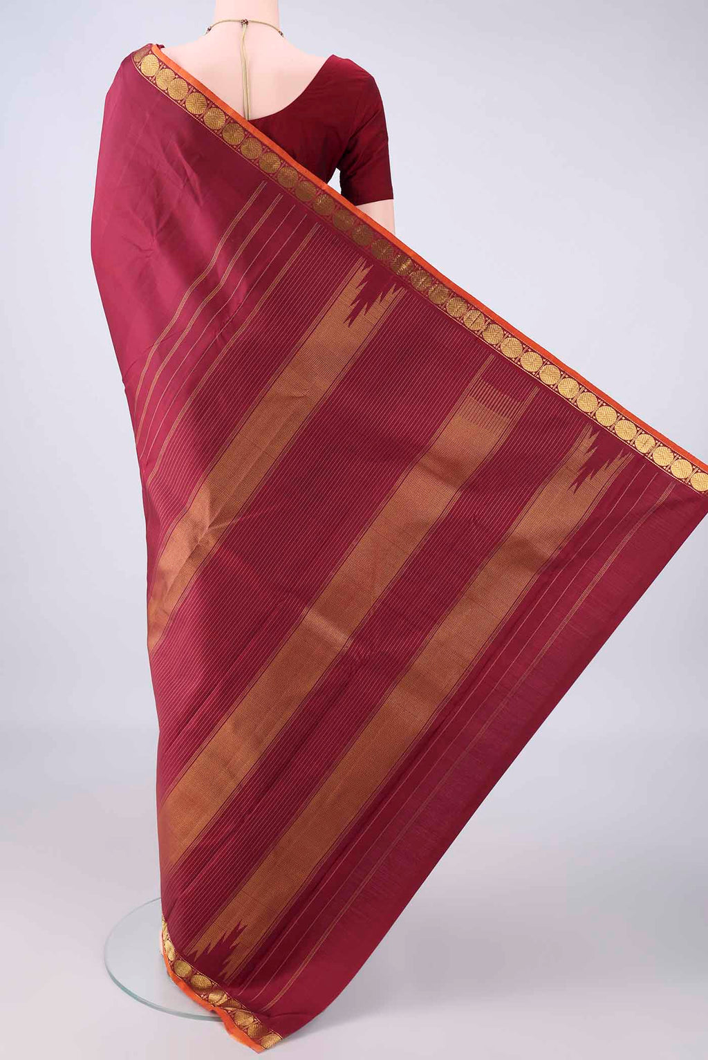 Flat view of Pure Silk Maroon Kanjivaram Saree with Plain Body and Zari Border. 