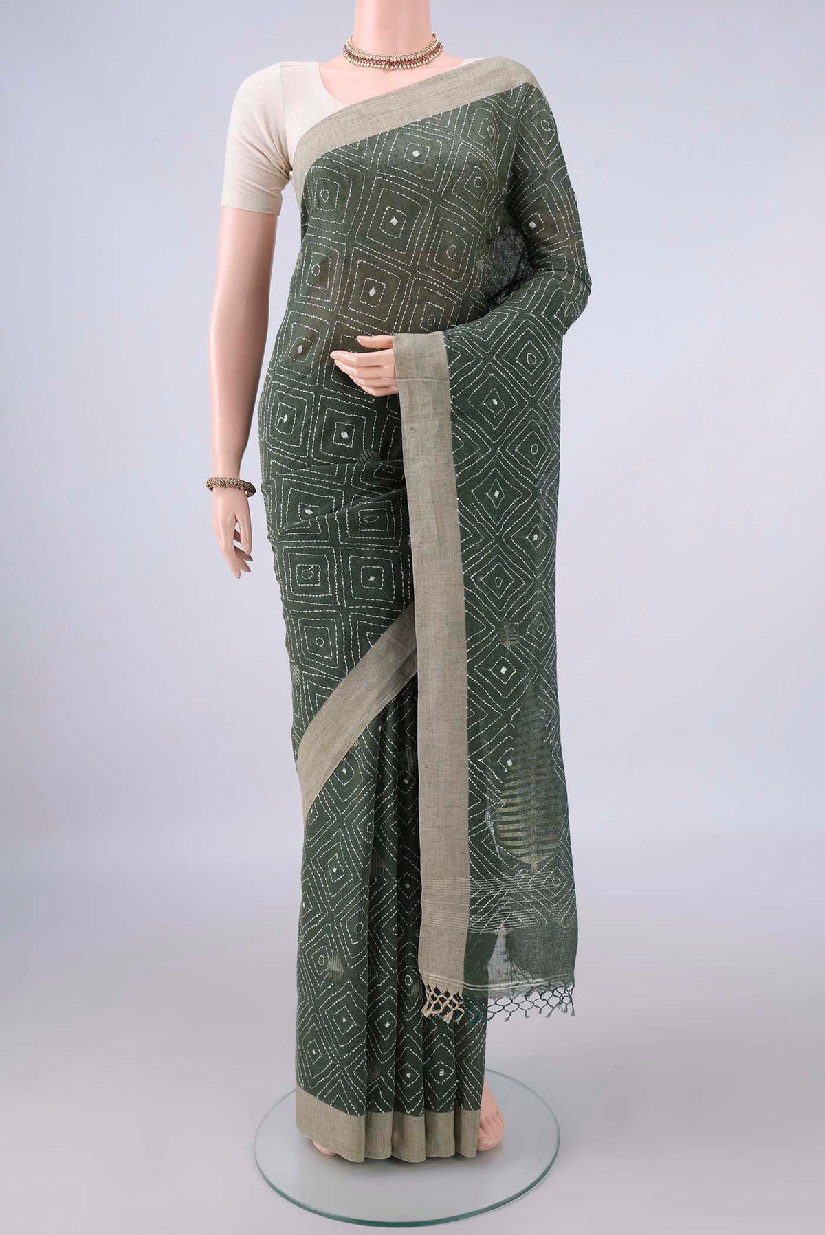 Olive Green Linen Saree with Kantha Work on the body and Plain Border.  displayed on a mannequin