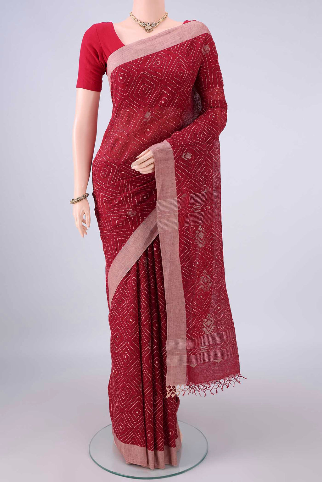 Red Linen Saree with Plain Body and Plain Border.  displayed on a mannequin