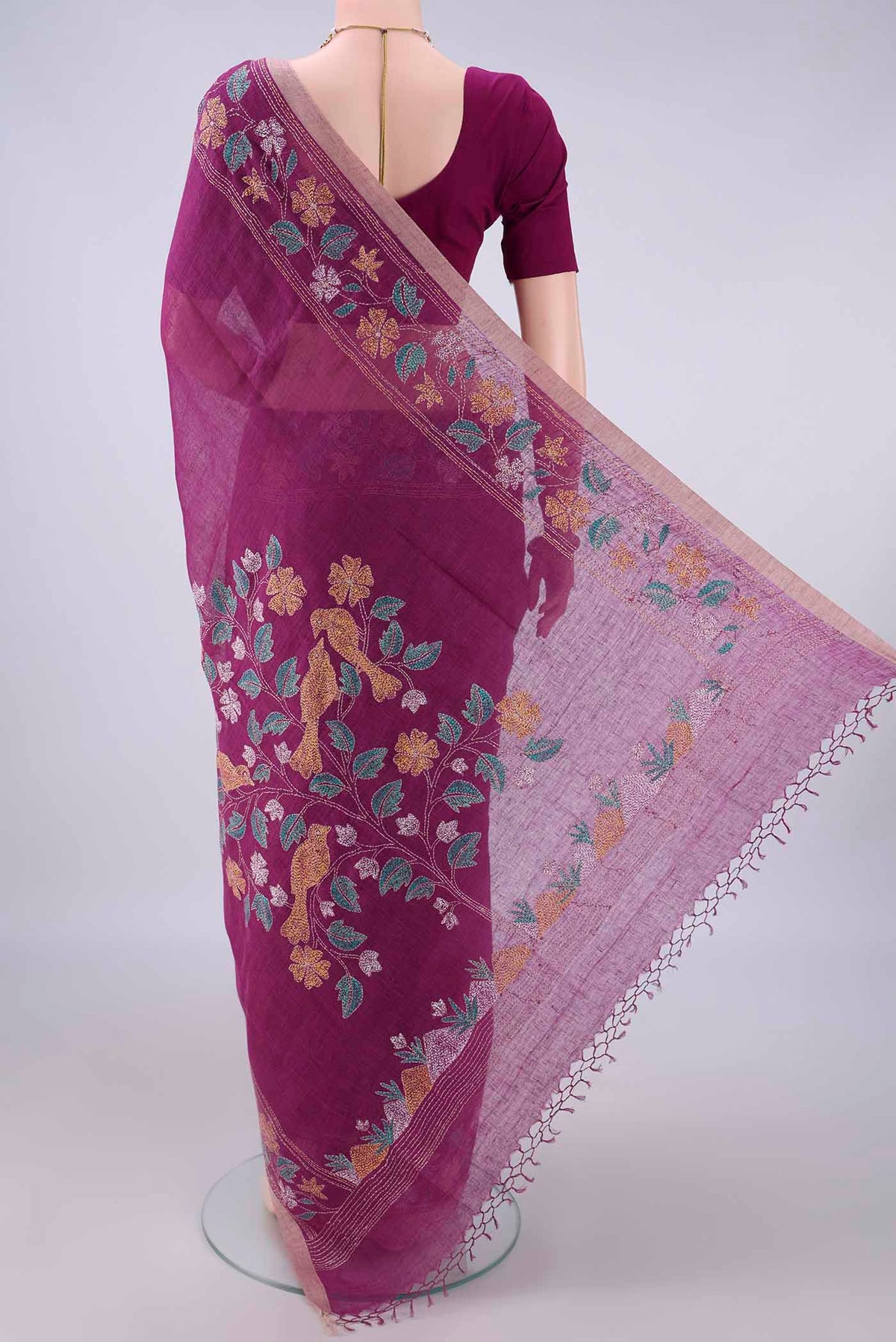Flat view of Magenta Linen Saree with Kantha Work on the body and Thread Border. 