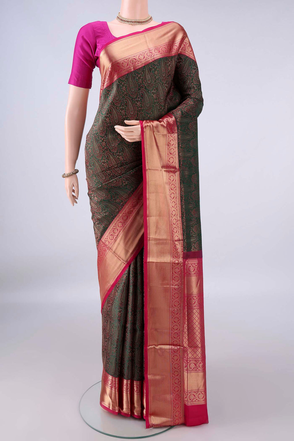Pure Silk Bottle Green Soft Saree with Jacquard design on the body and Zari Border.  displayed on a mannequin