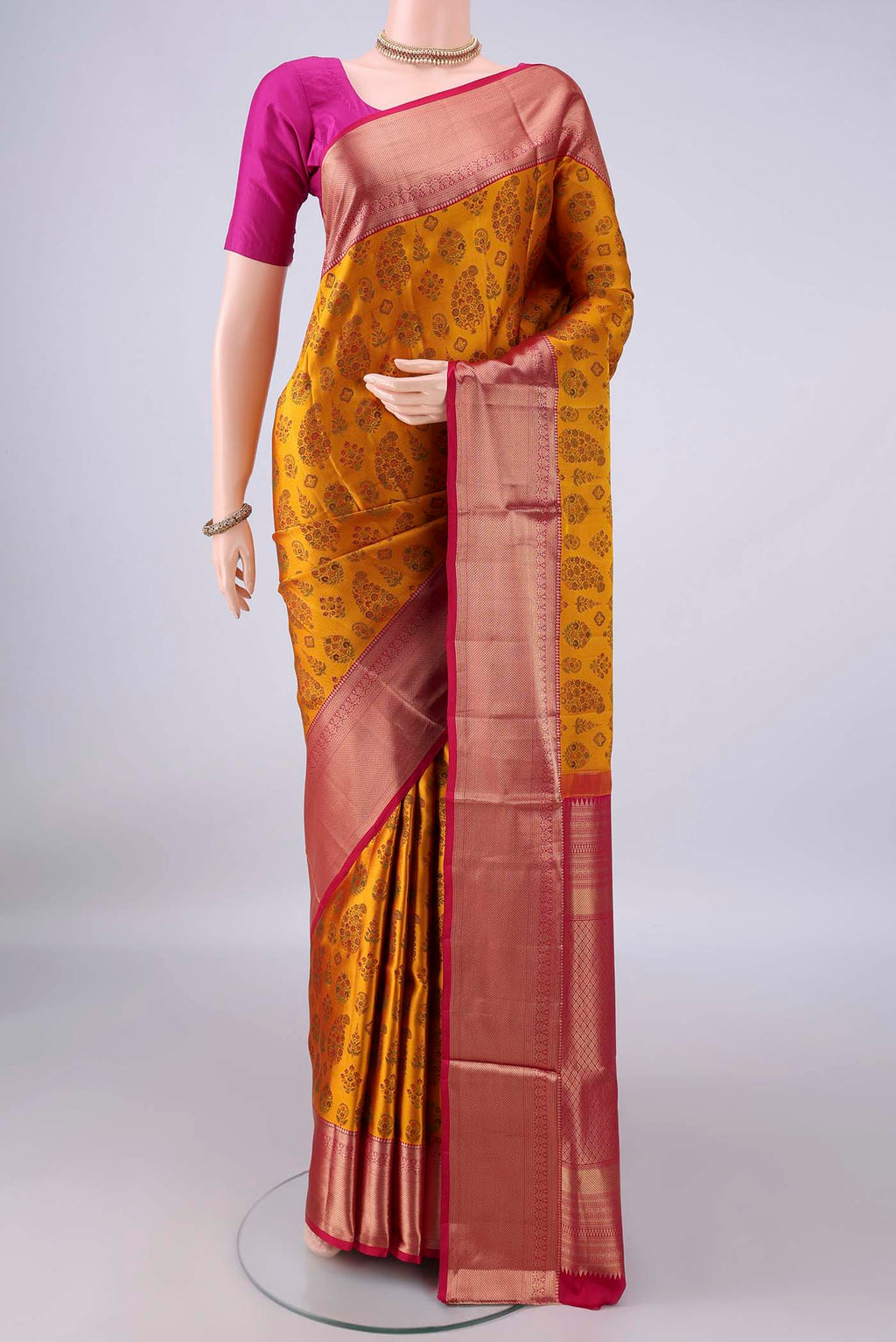 Pure Silk Mustard Soft Saree with Jacquard design on the body and Zari Border.  displayed on a mannequin