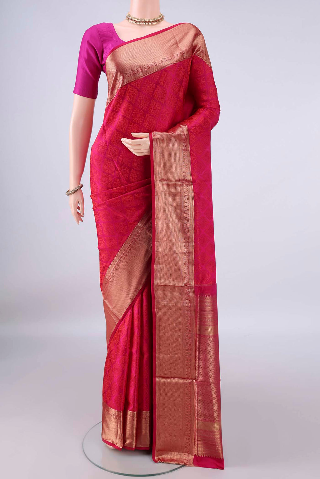Pure Silk Rani Pink Soft Saree with Jacquard design on the body and Zari Border.  displayed on a mannequin