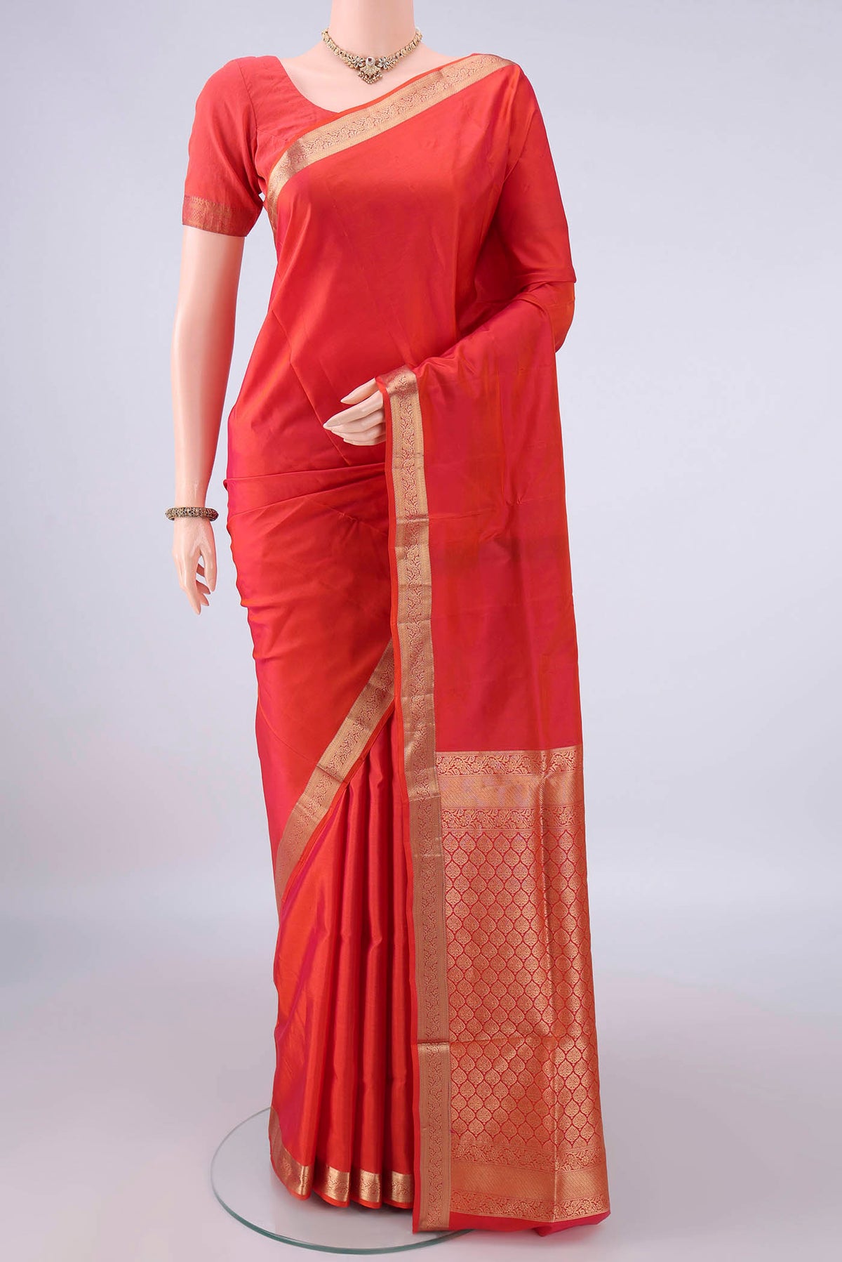 Pure Silk Brick Orange Soft Saree with Plain Body and Zari Border.  displayed on a mannequin