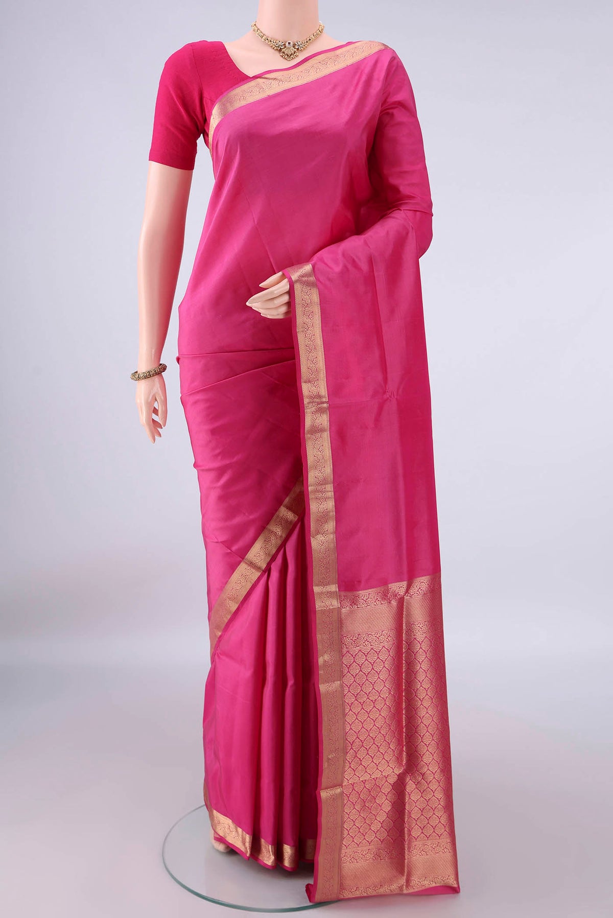 Pure Silk Pink Soft Saree with Plain Body and Zari Border.  displayed on a mannequin
