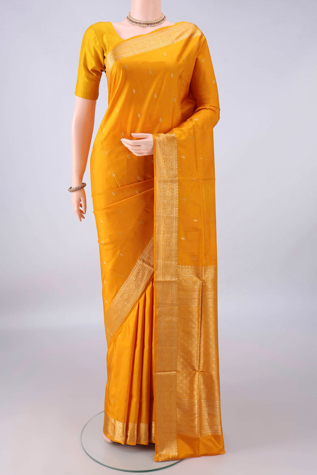 Pure Silk Yellow Soft Saree with Zari Butta on the body and Zari Border.  displayed on a mannequin