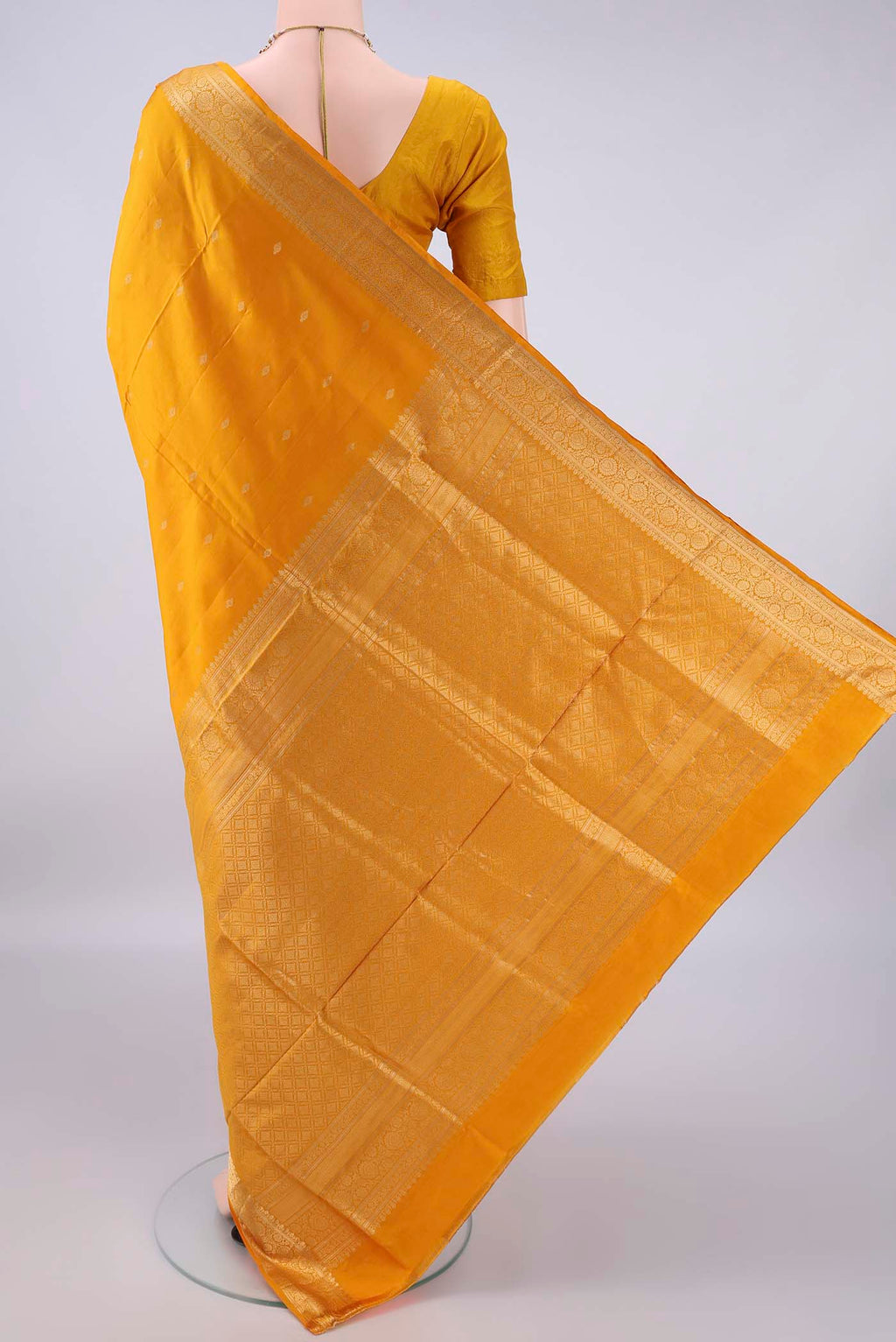 Flat view of Pure Silk Yellow Soft Saree with Zari Butta on the body and Zari Border. 