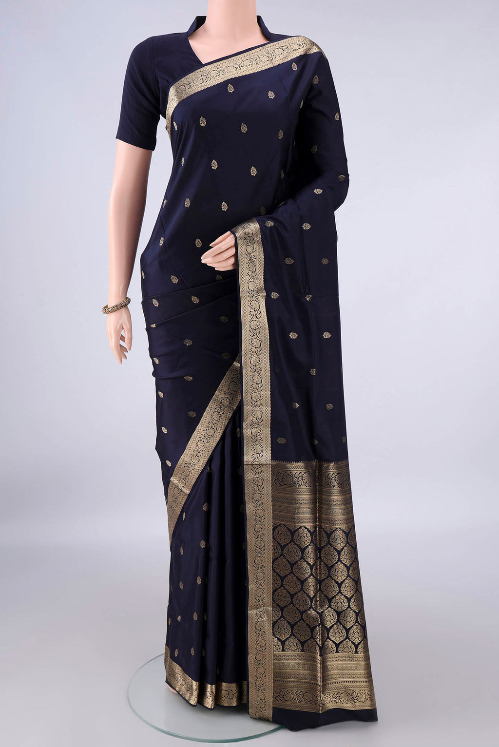 Pure Silk Navy Blue Soft Saree with Zari Butta on the body and Zari Border.  displayed on a mannequin