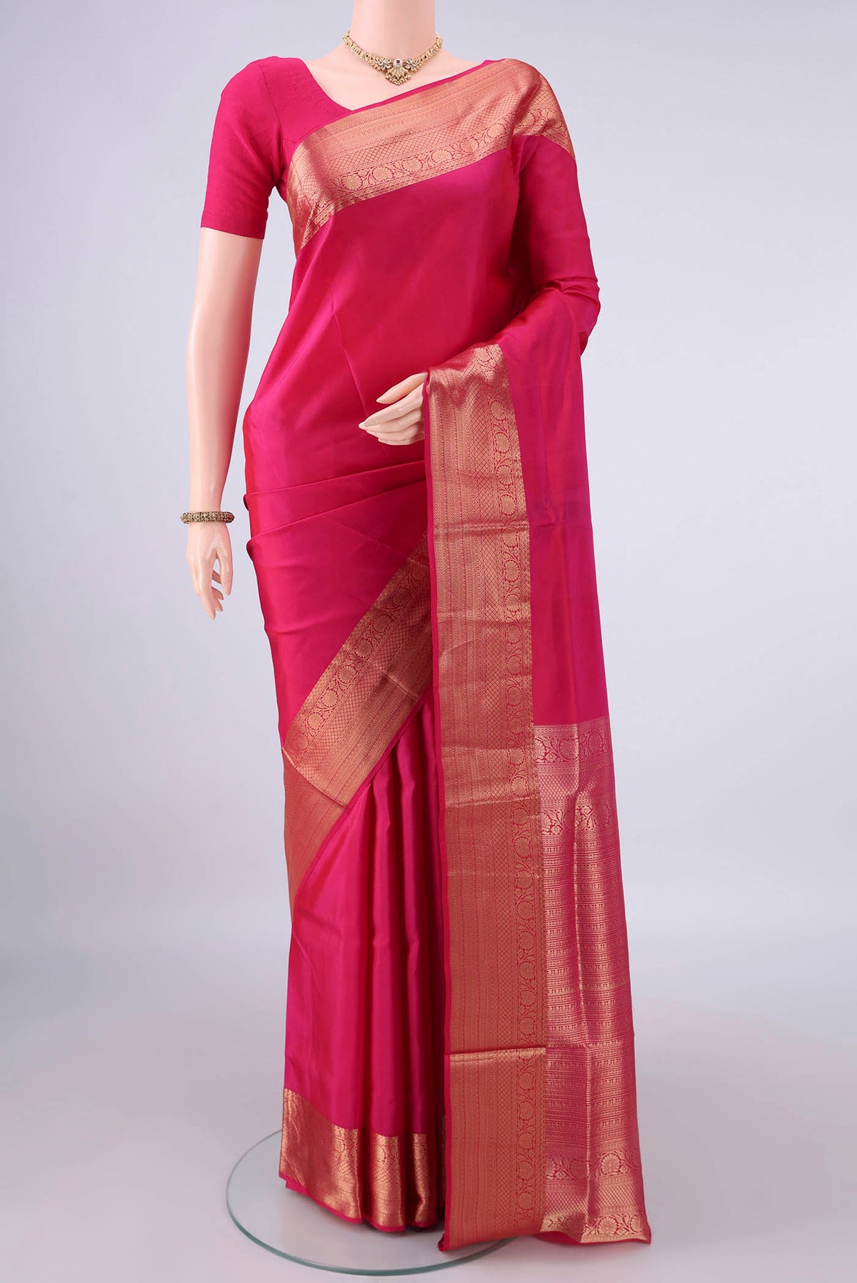 Pure Silk Rani Pink Soft Saree with Plain Body and Zari Border.  displayed on a mannequin
