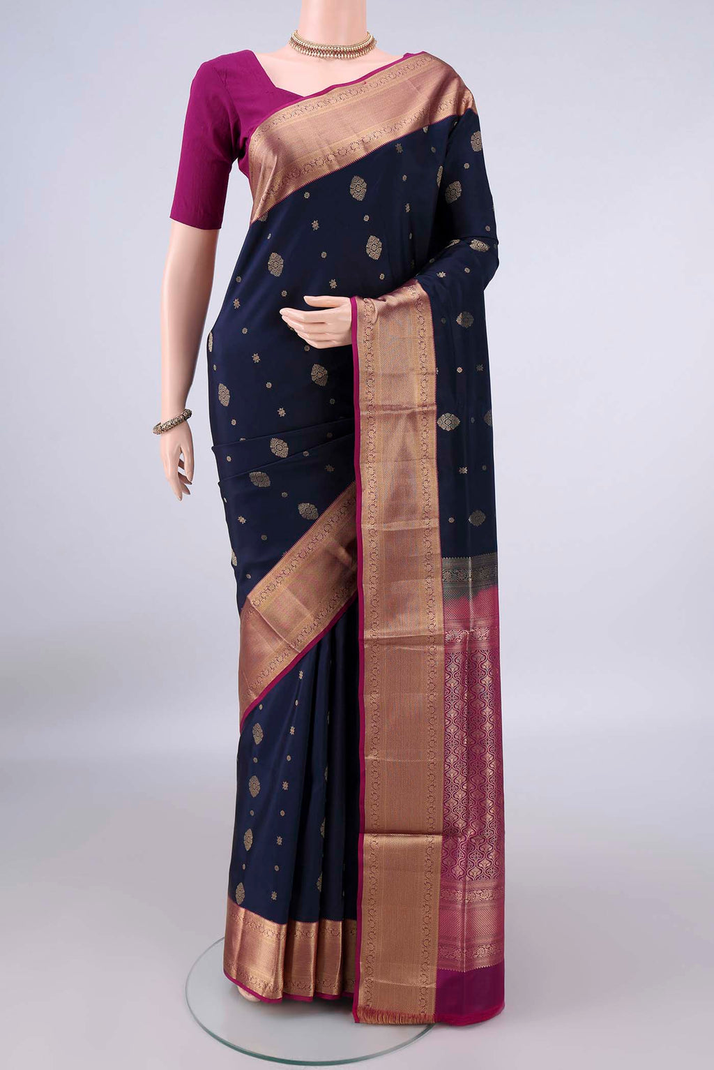 Pure Silk Navy Blue Soft Saree with Zari Butta on the body and Zari Border.  displayed on a mannequin