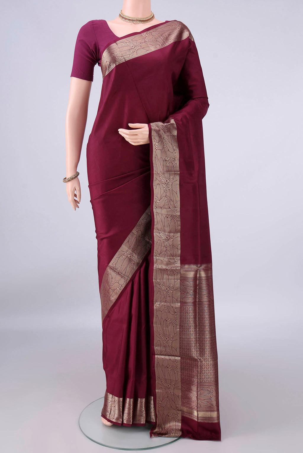 Pure Silk Maroon Soft Saree with Plain Body and Zari Border.  displayed on a mannequin