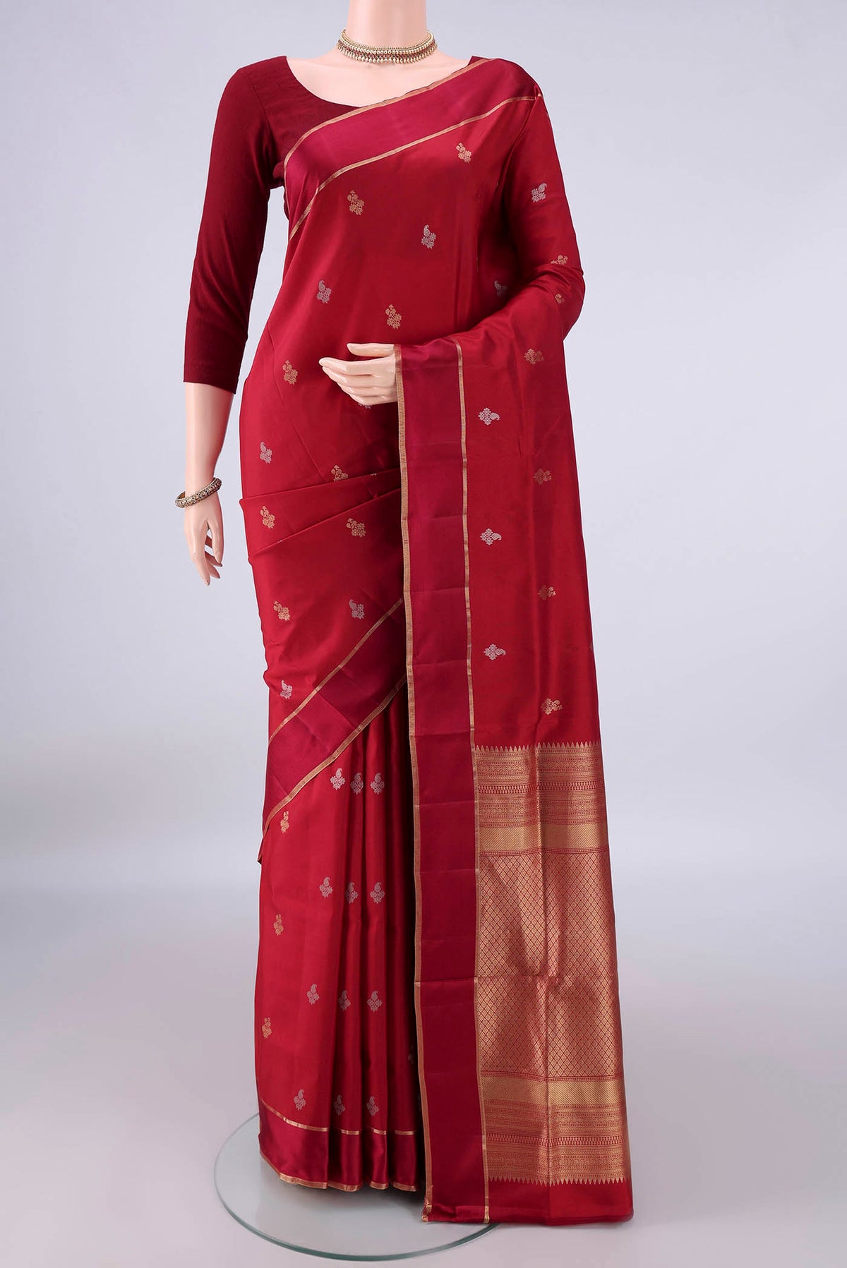 Pure Silk Maroon Soft Saree with Zari Butta on the body and Zari Border.  displayed on a mannequin