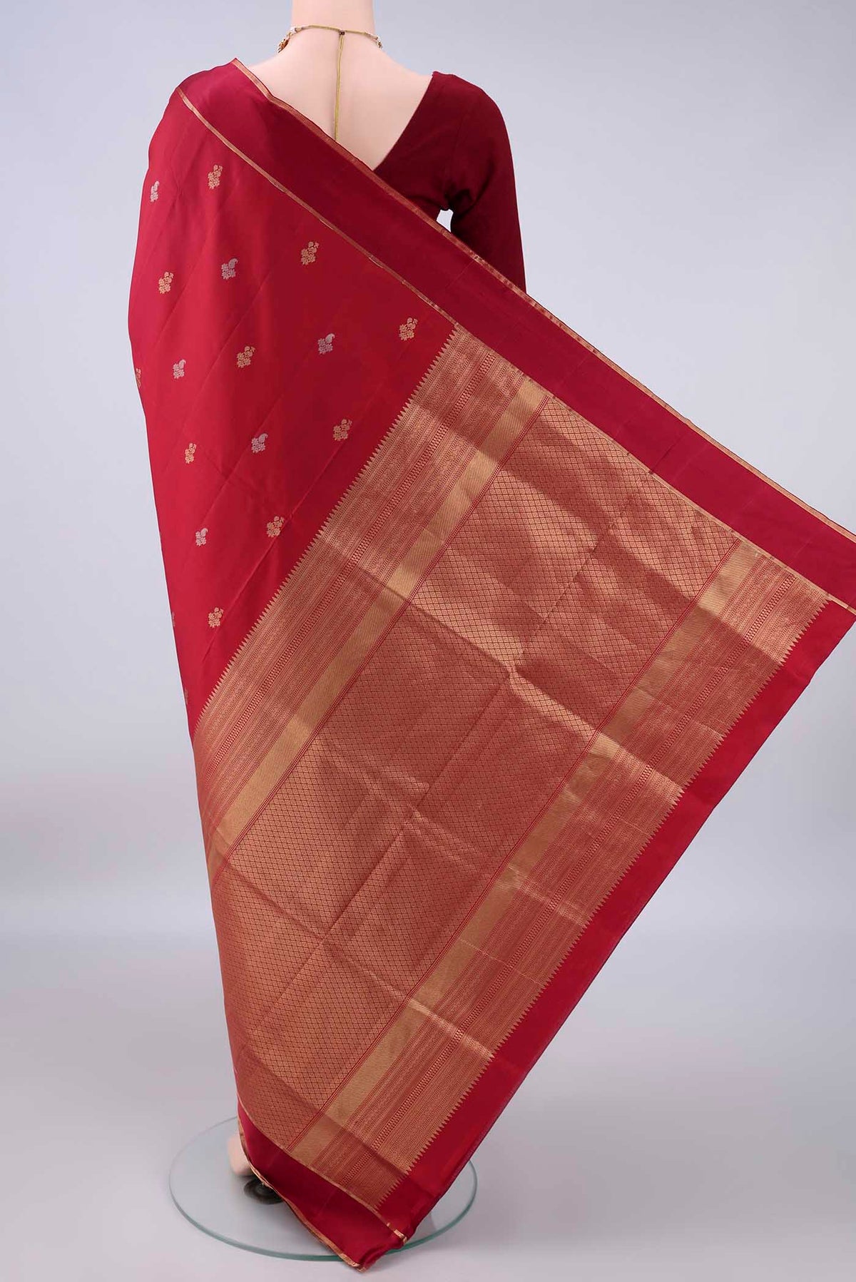 Flat view of Pure Silk Maroon Soft Saree with Zari Butta on the body and Zari Border. 