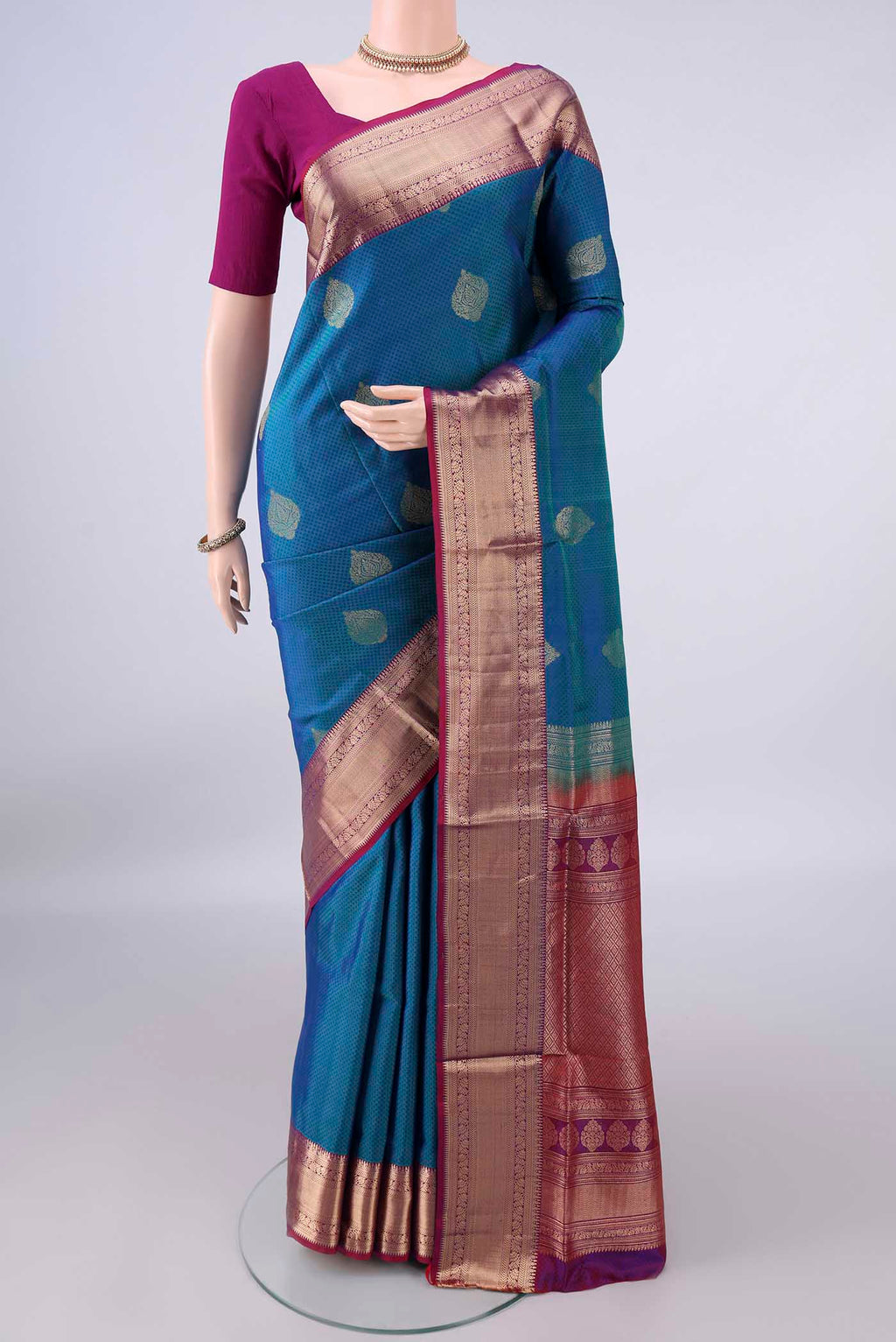 Pure Silk Peacock Blue Soft Saree with Jacquard design on the body and Zari Border.  displayed on a mannequin