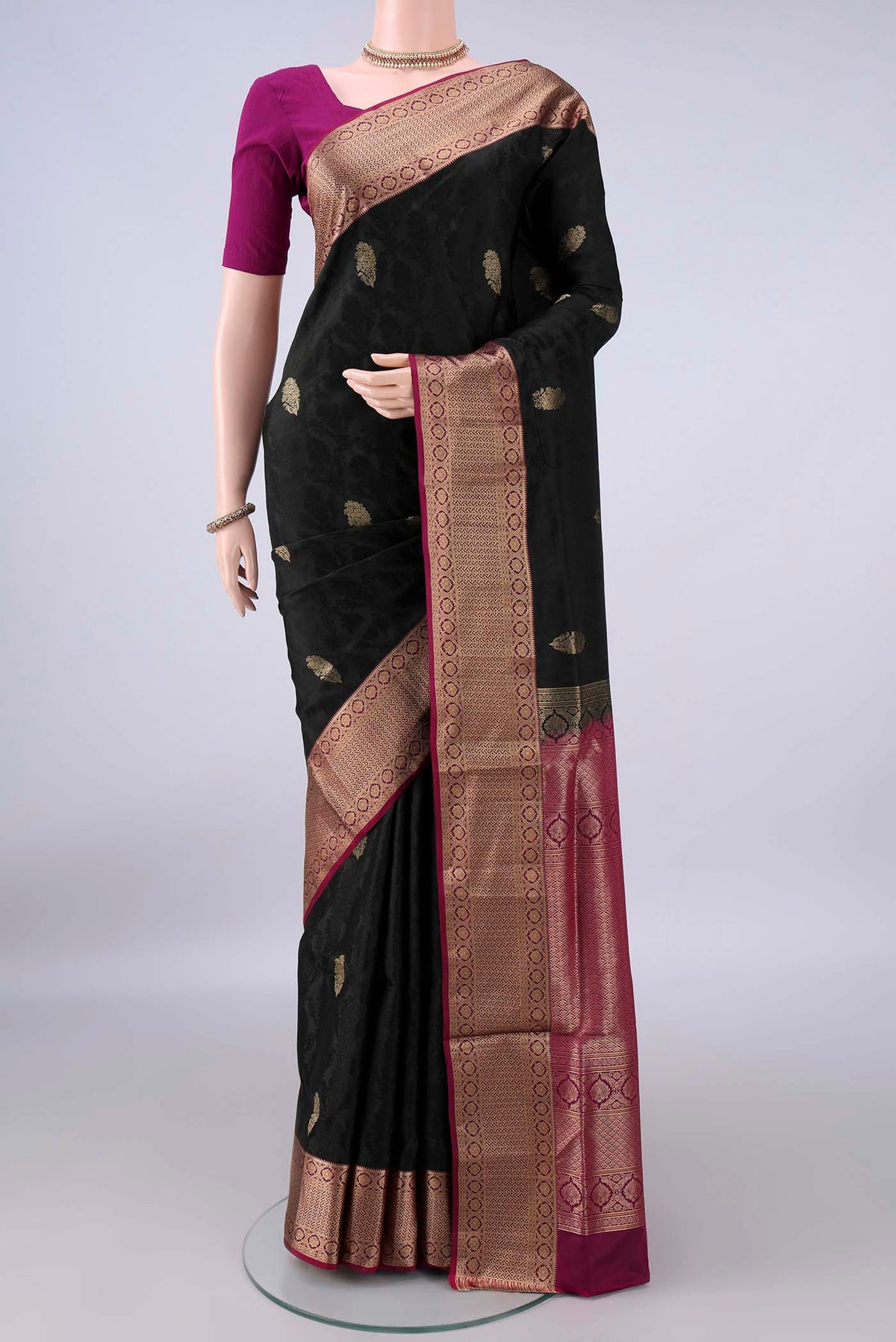 Pure Silk Black Soft Saree with Jacquard design on the body and Zari Border.  displayed on a mannequin