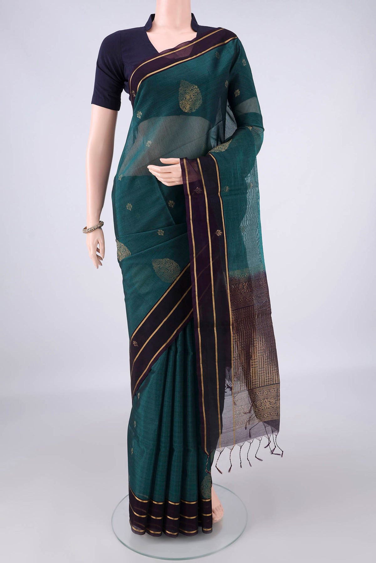 Peacock Blue Silk Cotton Saree with Zari Butta on the body and Zari Border.  displayed on a mannequin