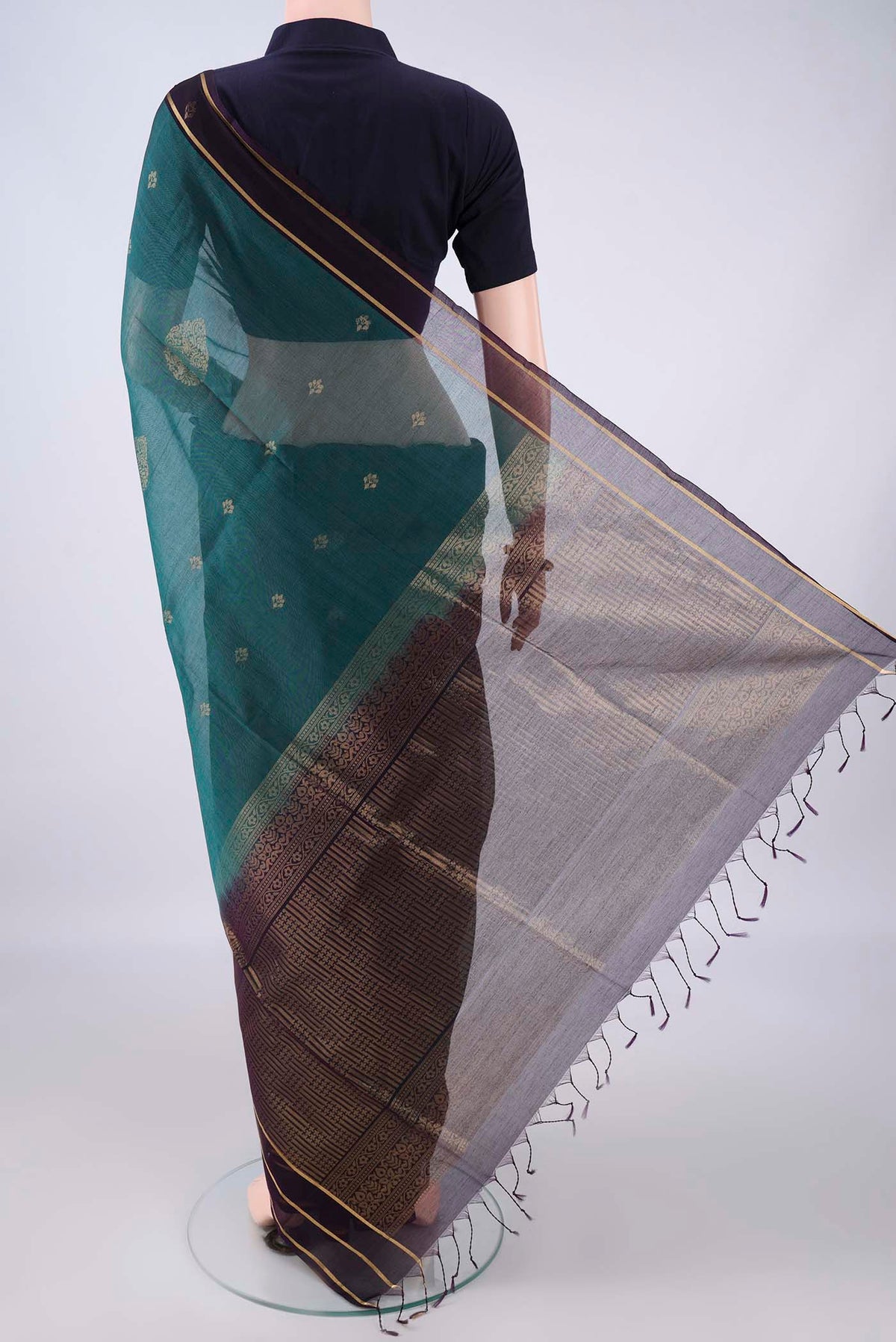Flat view of Peacock Blue Silk Cotton Saree with Zari Butta on the body and Zari Border. 