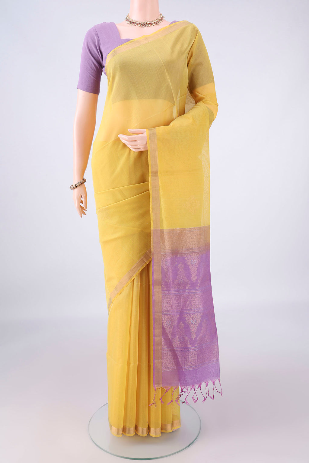 Lemon Yellow Silk Cotton Saree with Zari Butta on the body and Zari Border.  displayed on a mannequin