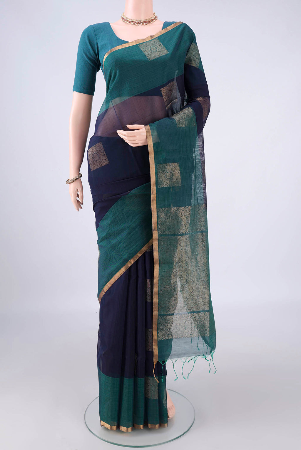 Navy Blue Silk Cotton Saree with Zari Butta on the body and Plain Border.  displayed on a mannequin