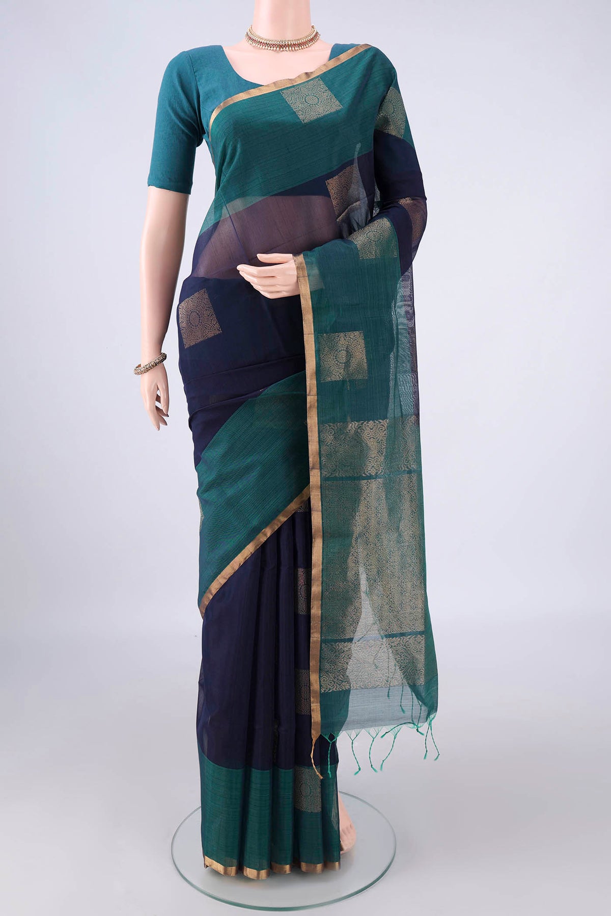 Navy Blue Silk Cotton Saree with Zari Butta on the body and Plain Border.  displayed on a mannequin