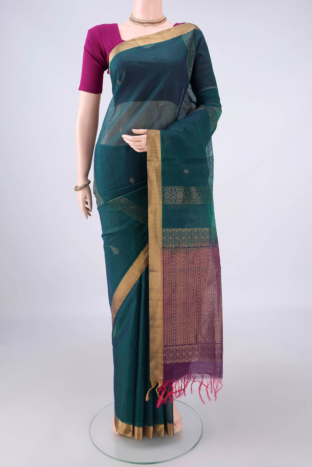 Teal Silk Cotton Saree with Zari Butta on the body and Zari Border.  displayed on a mannequin