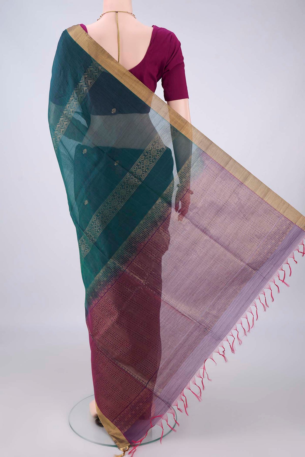 Flat view of Teal Silk Cotton Saree with Zari Butta on the body and Zari Border. 