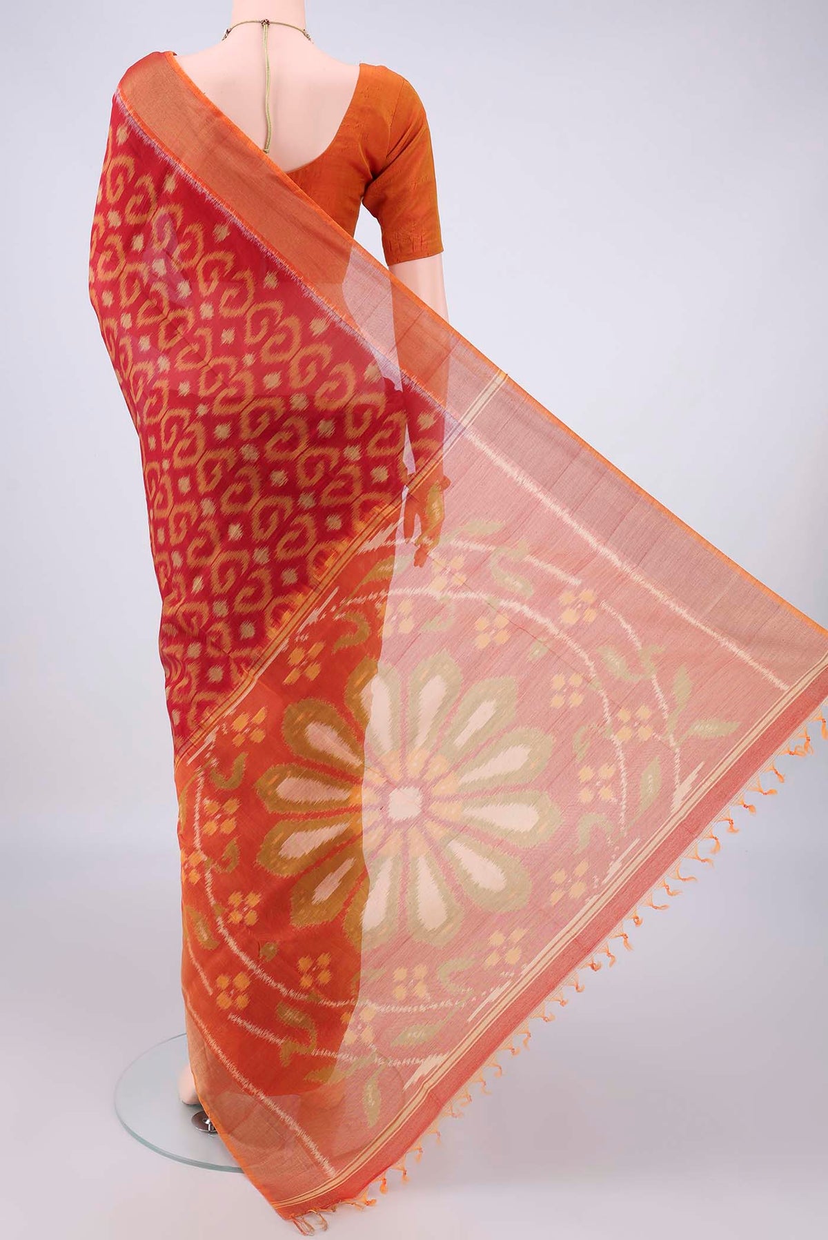 Flat view of Red Silk Cotton Saree with Ikat design on the body and Zari Border. 