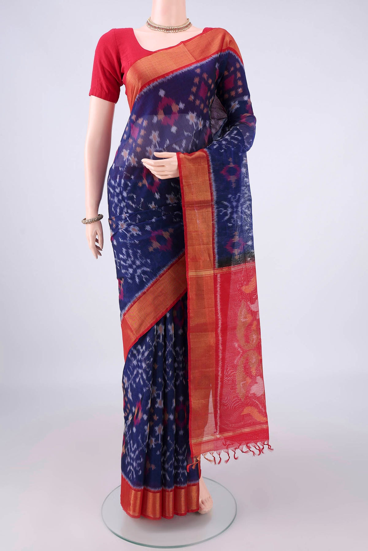 Dark Blue Silk Cotton Saree with Ikat design on the body and Zari Border.  displayed on a mannequin