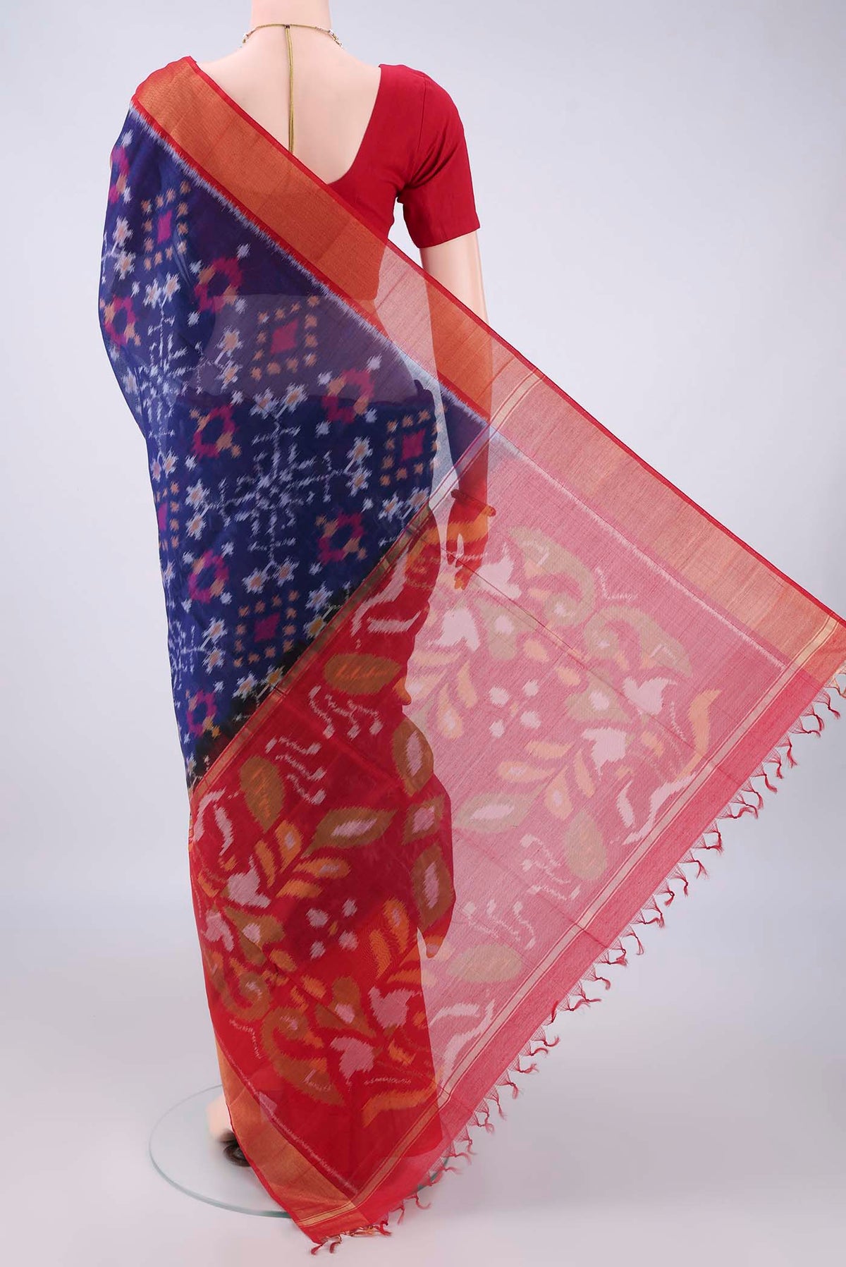 Flat view of Dark Blue Silk Cotton Saree with Ikat design on the body and Zari Border. 
