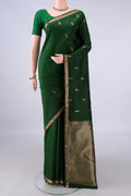 Pure Silk Bottle Green Kanjivaram Saree with Zari Butta on the body and Zari Border.  displayed on a mannequin