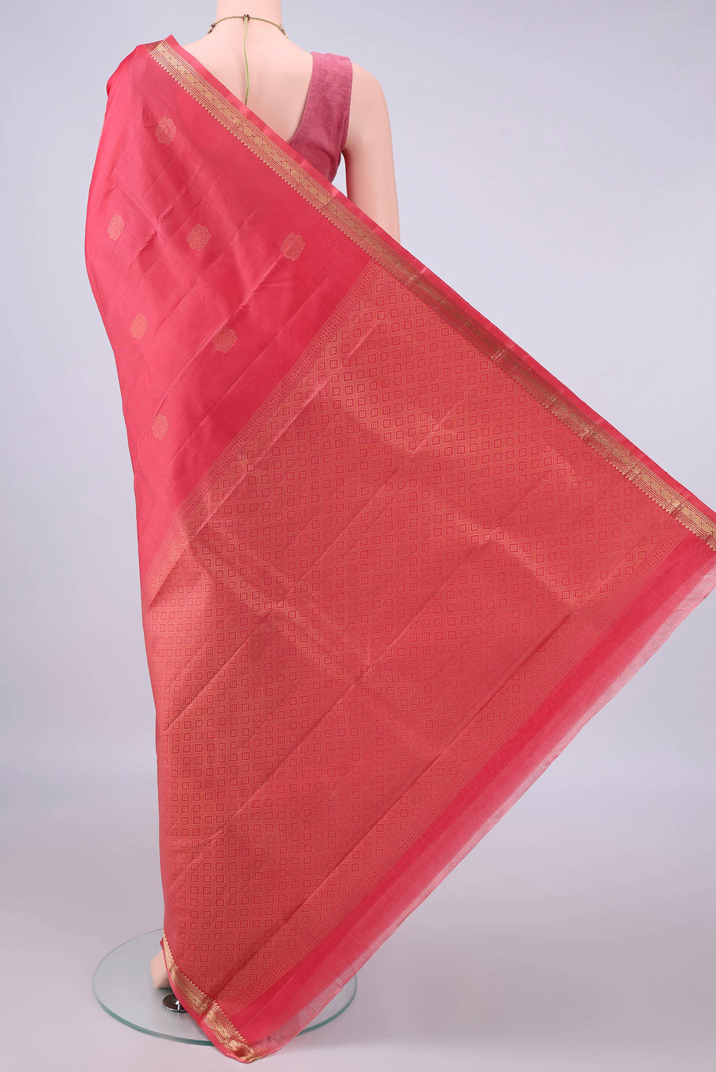 Flat view of Pure Silk Coral Kanjivaram Saree with Zari Butta on the body and Zari Border. 