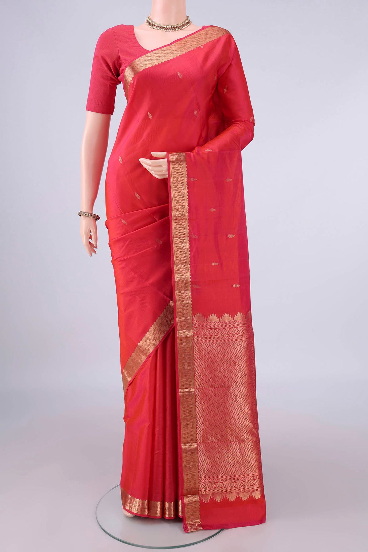 Pure Silk Red Kanjivaram Saree with Zari Butta on the body and Zari Border.  displayed on a mannequin