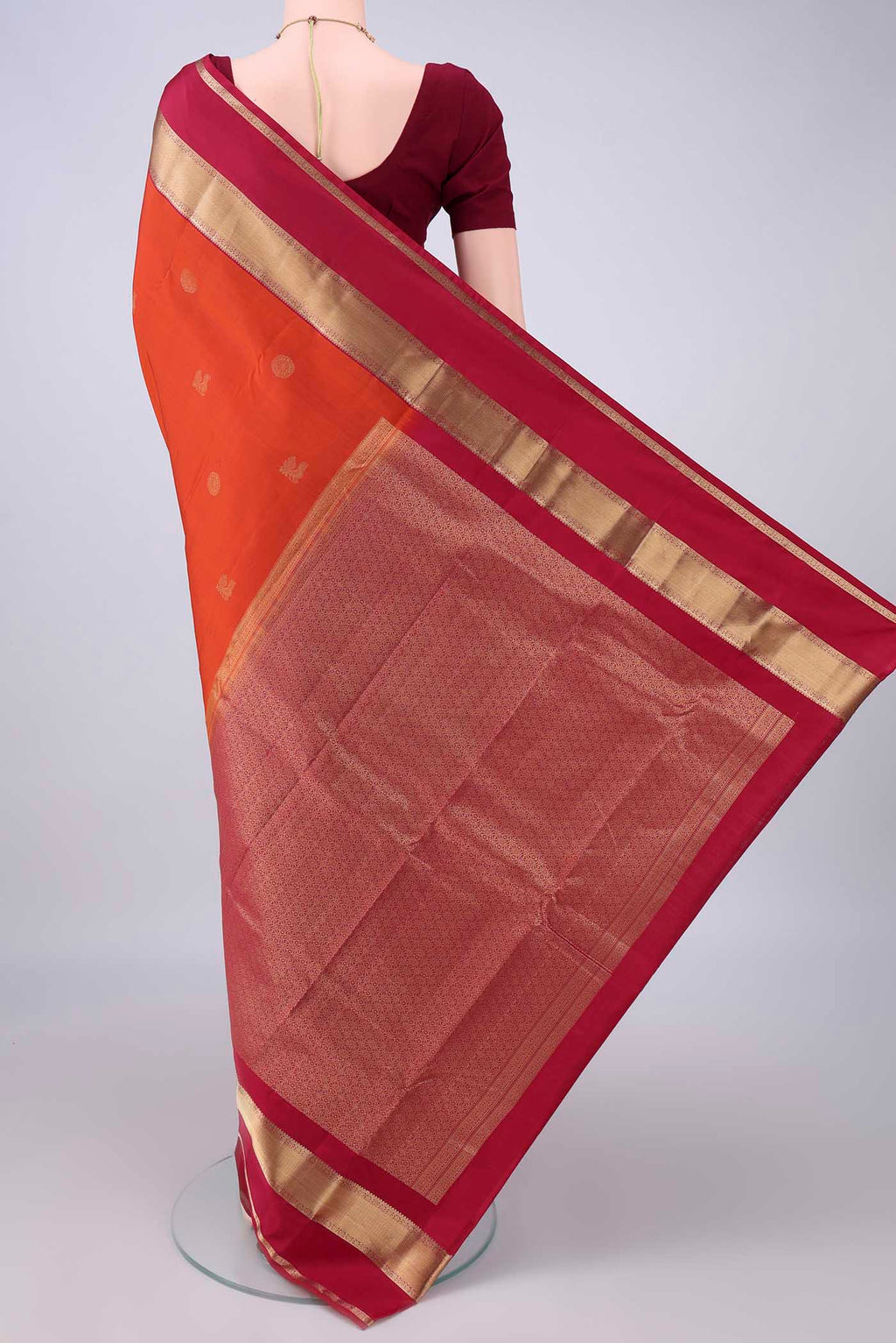 Flat view of Pure Silk Orange Kanchipuram Saree with Zari Butta on the body and Zari Border. 