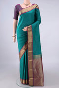Pure Silk Sea Green Kanchipuram Saree with Zari Butta on the body and Zari Border.  displayed on a mannequin