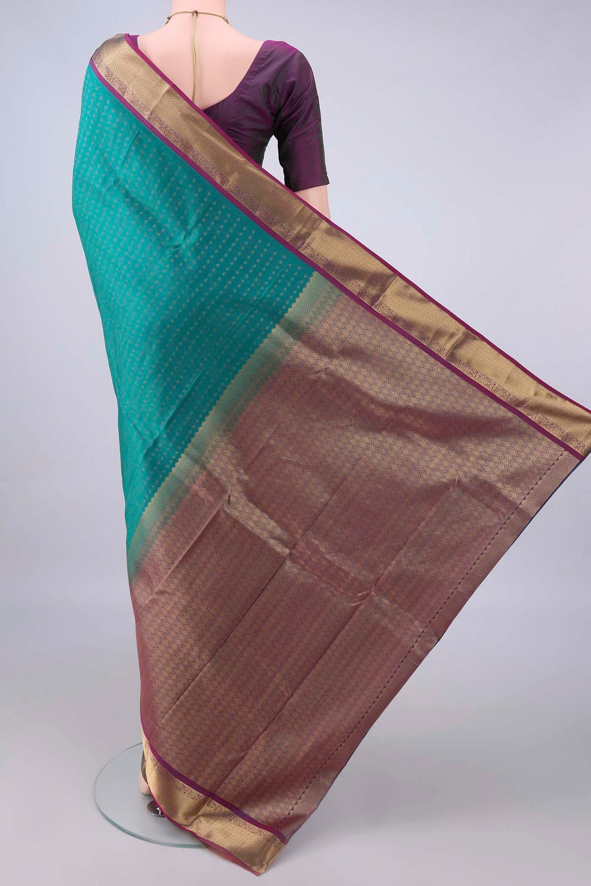 Flat view of Pure Silk Sea Green Kanchipuram Saree with Zari Butta on the body and Zari Border. 