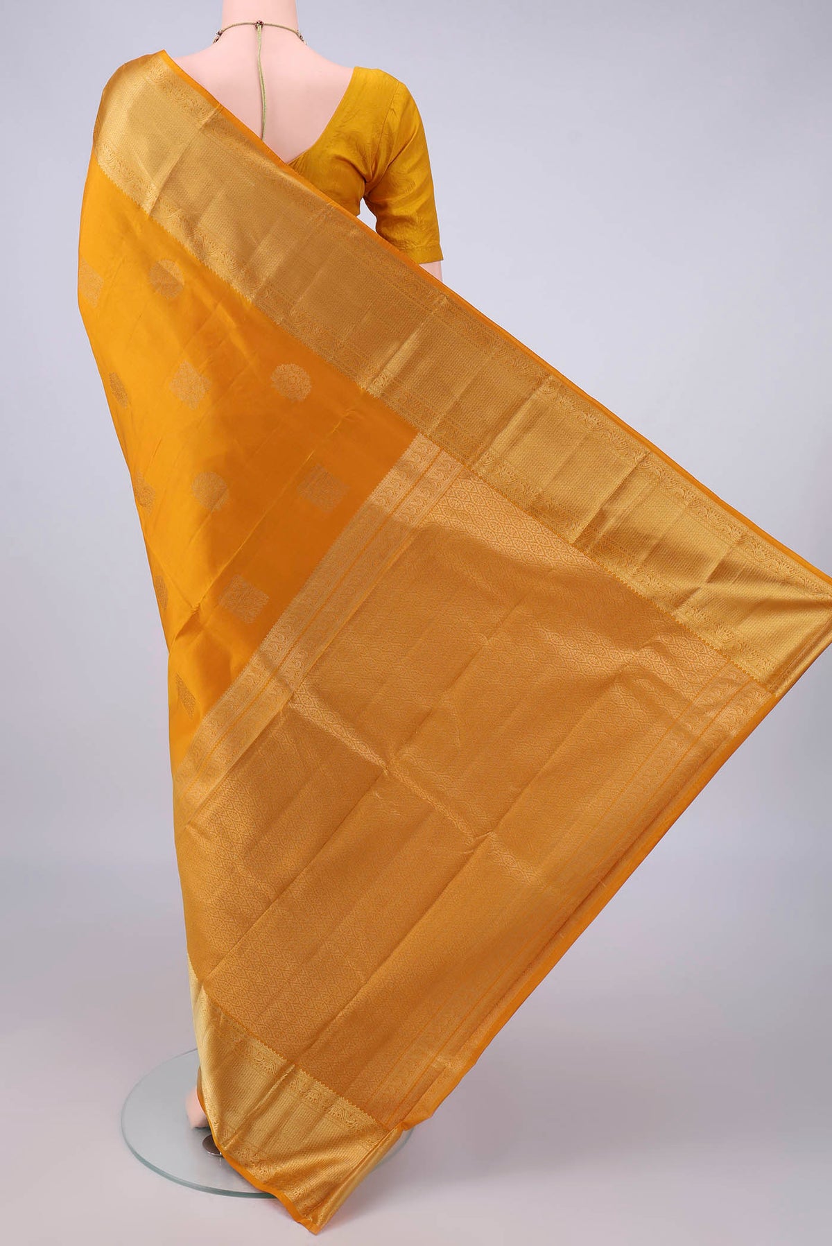 Flat view of Pure Silk Mustard Kanchipuram Saree with Zari Butta on the body and Zari Border. 