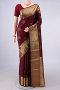 Pure Silk Maroon Kanchipuram Saree with Zari Butta on the body and Zari Border.  displayed on a mannequin