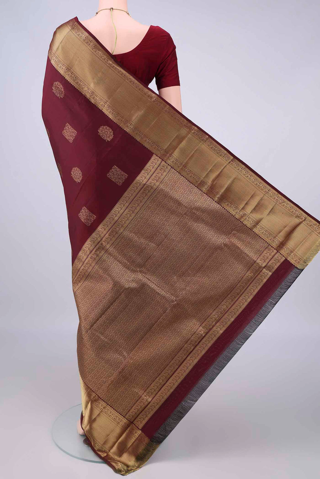 Flat view of Pure Silk Maroon Kanchipuram Saree with Zari Butta on the body and Zari Border. 