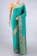 Pure Silk Sea Green Kanchipuram Saree with Zari Butta on the body and Zari Border.  displayed on a mannequin