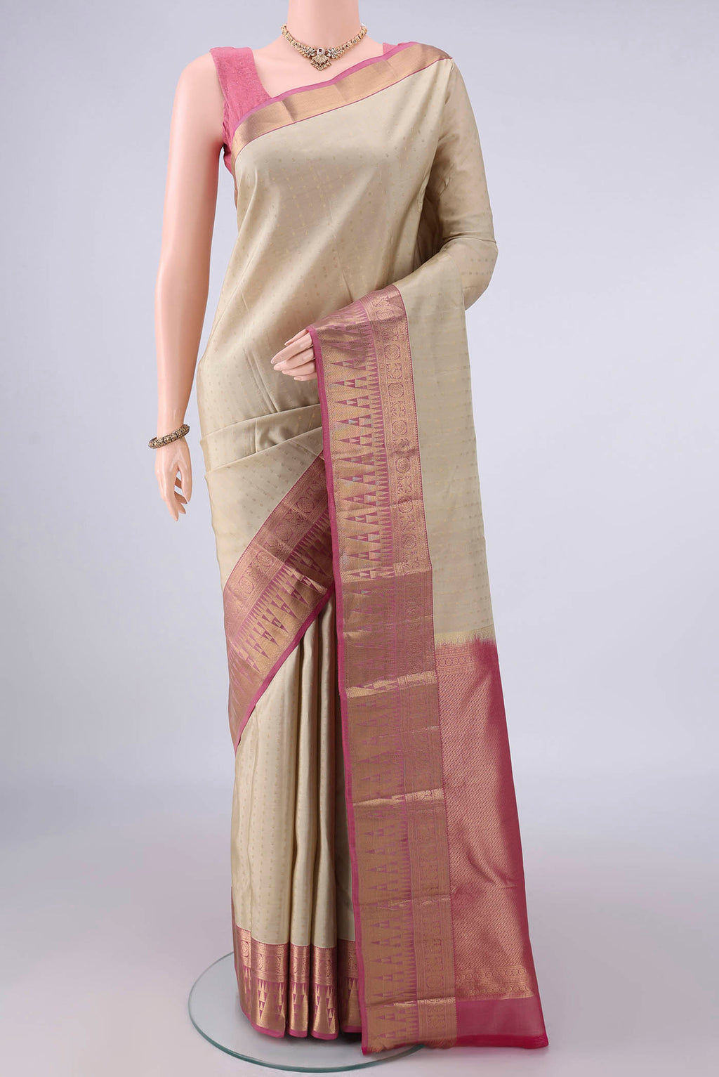Pure Silk Beige Kanchipuram Saree with Zari Butta on the body and Zari Border.  displayed on a mannequin