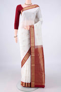 Pure Silk White Kanchipuram Saree with Zari Butta on the body and Zari Border.  displayed on a mannequin