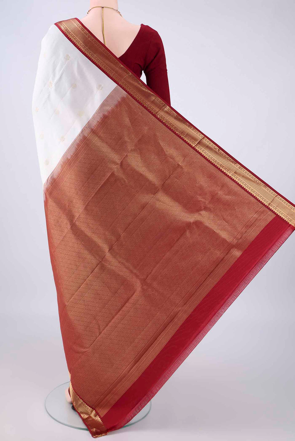 Flat view of Pure Silk White Kanchipuram Saree with Zari Butta on the body and Zari Border. 