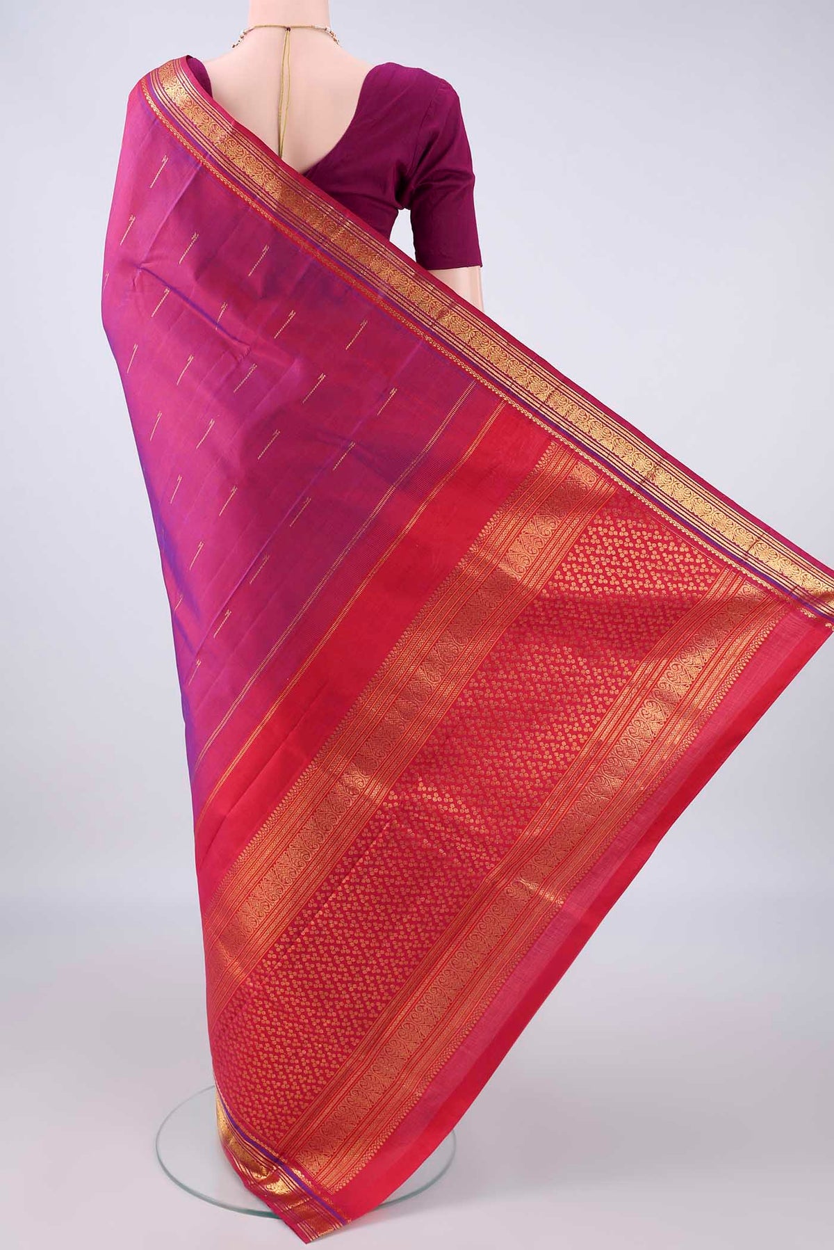 Flat view of Pure Silk Magenta Kanchipuram Saree with Zari Butta on the body and Zari Border. 