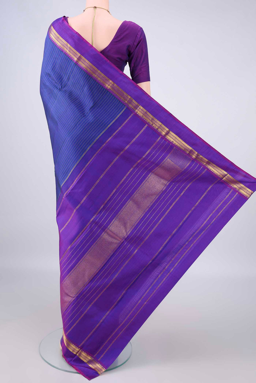 Flat view of Pure Silk Blue Kanchipuram Saree with Stripes on the body and Zari Border. 
