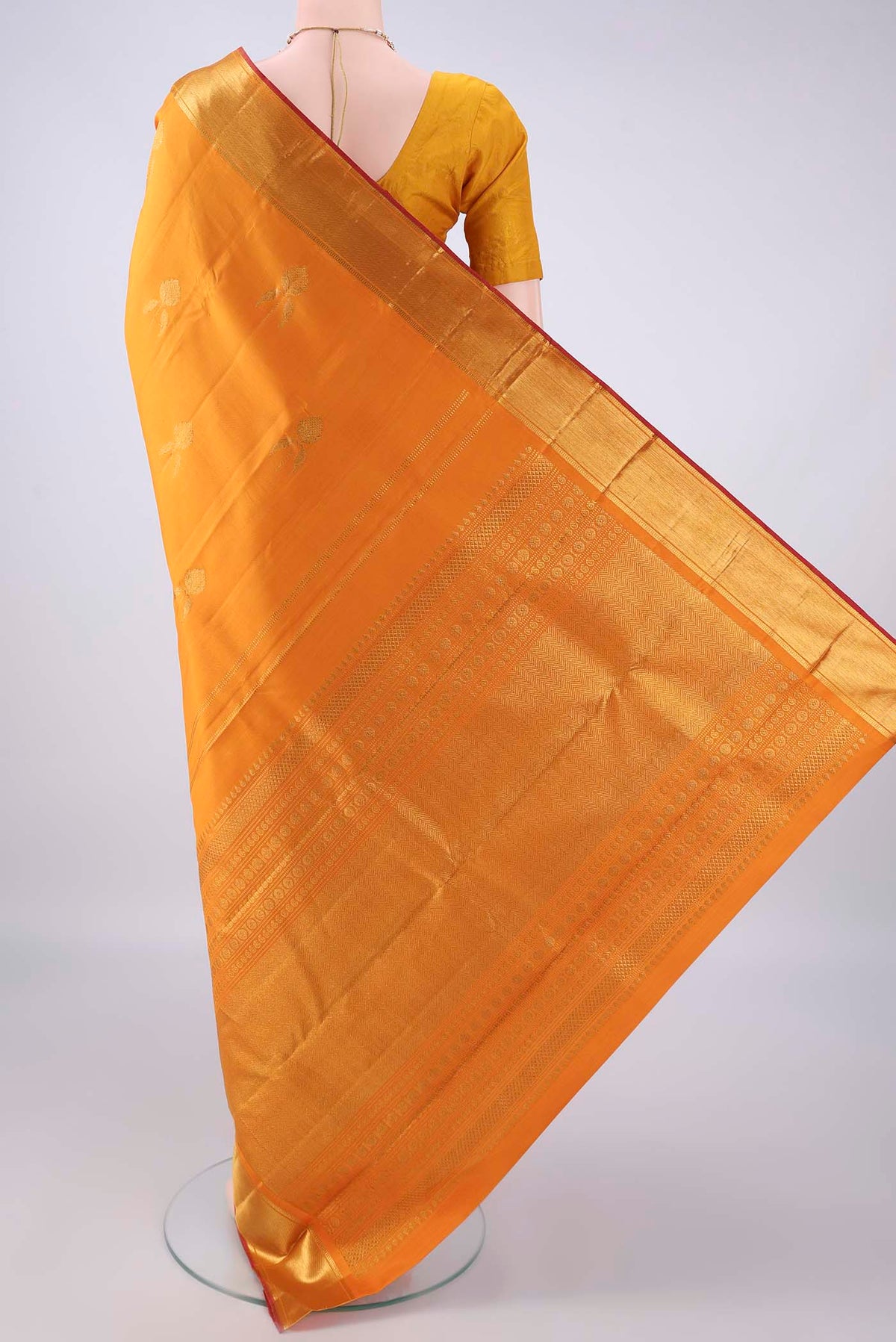 Flat view of Pure Silk Mustard Kanjivaram Saree with Zari Butta on the body and Zari Border. 
