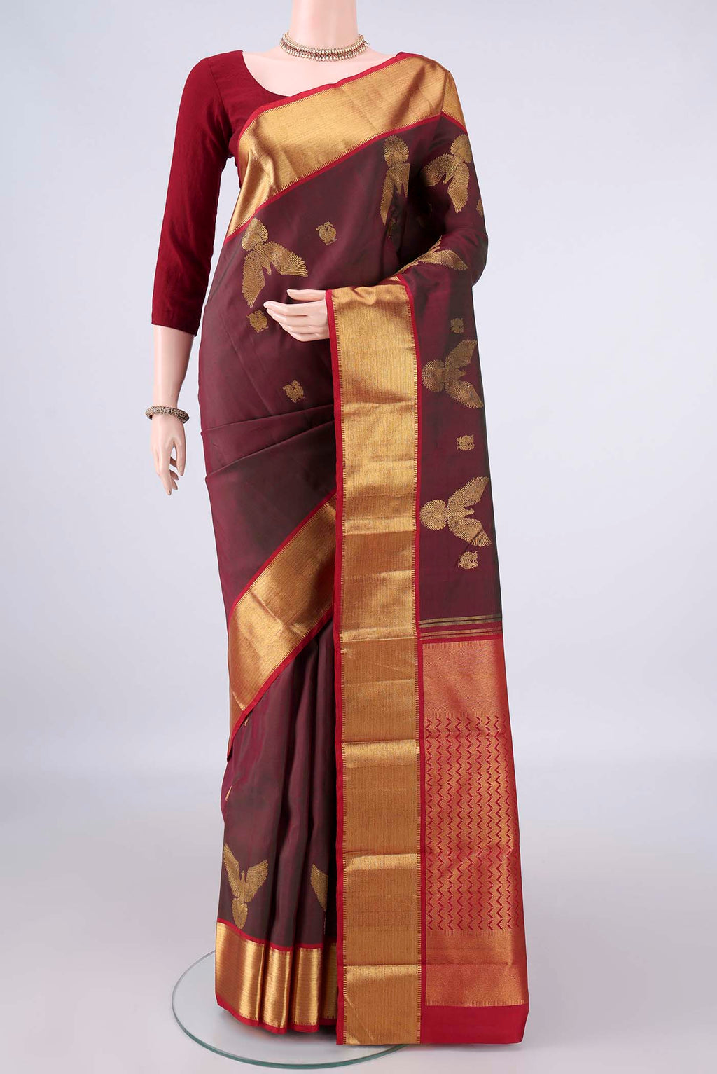 Pure Silk Maroon Dual Tone Kanjivaram Saree with Zari Butta on the body and Zari Border.  displayed on a mannequin