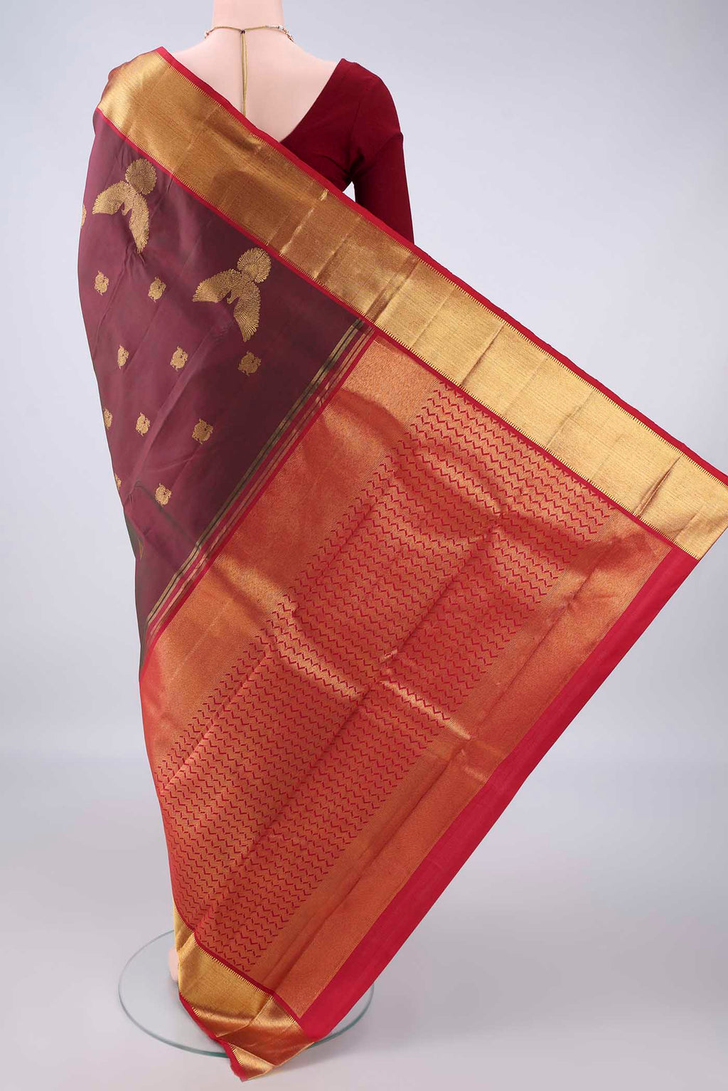 Flat view of Pure Silk Maroon Dual Tone Kanjivaram Saree with Zari Butta on the body and Zari Border. 