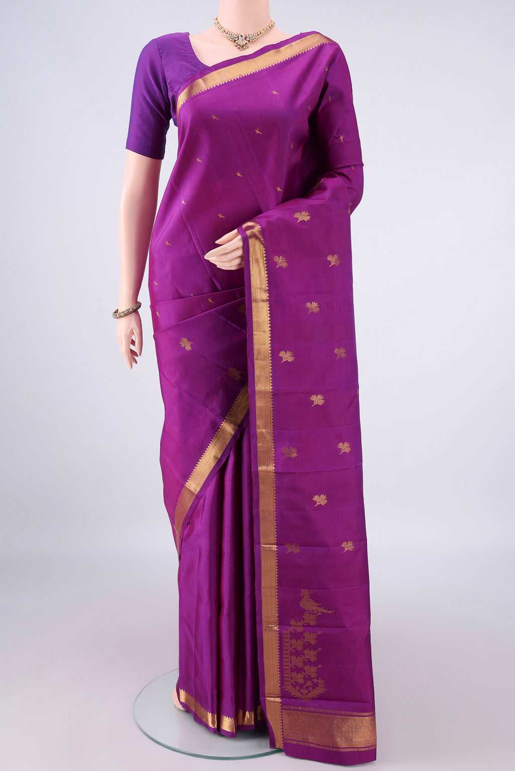 Pure Silk Purple Kanjivaram Saree with Zari Butta on the body and Zari Border.  displayed on a mannequin