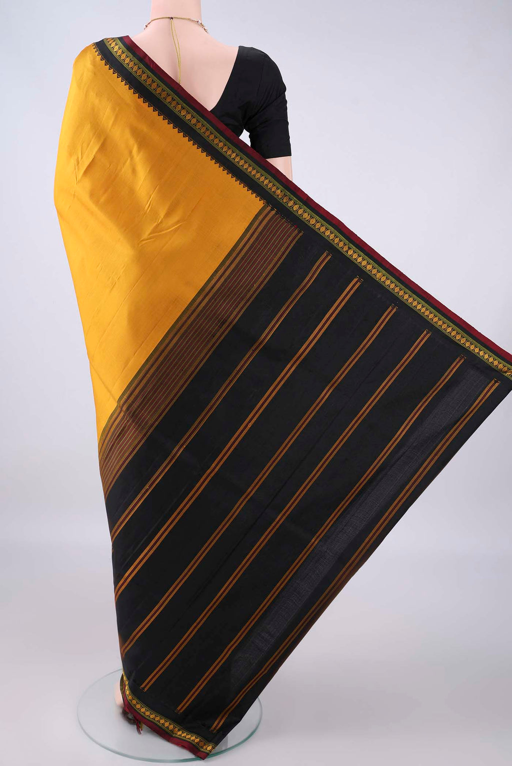 Flat view of Pure Silk Mustard Kanjivaram Saree with Plain Body and Thread Border. 