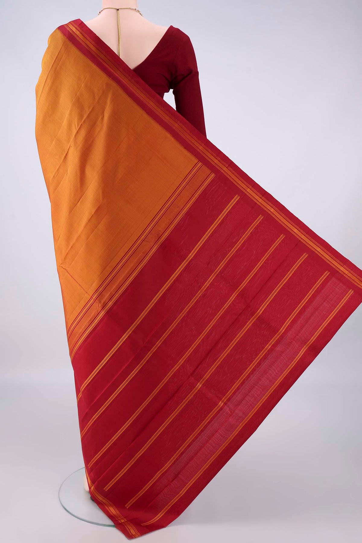 Flat view of Pure Silk Mustard Kanjivaram Saree with Plain Body and Thread Border. 